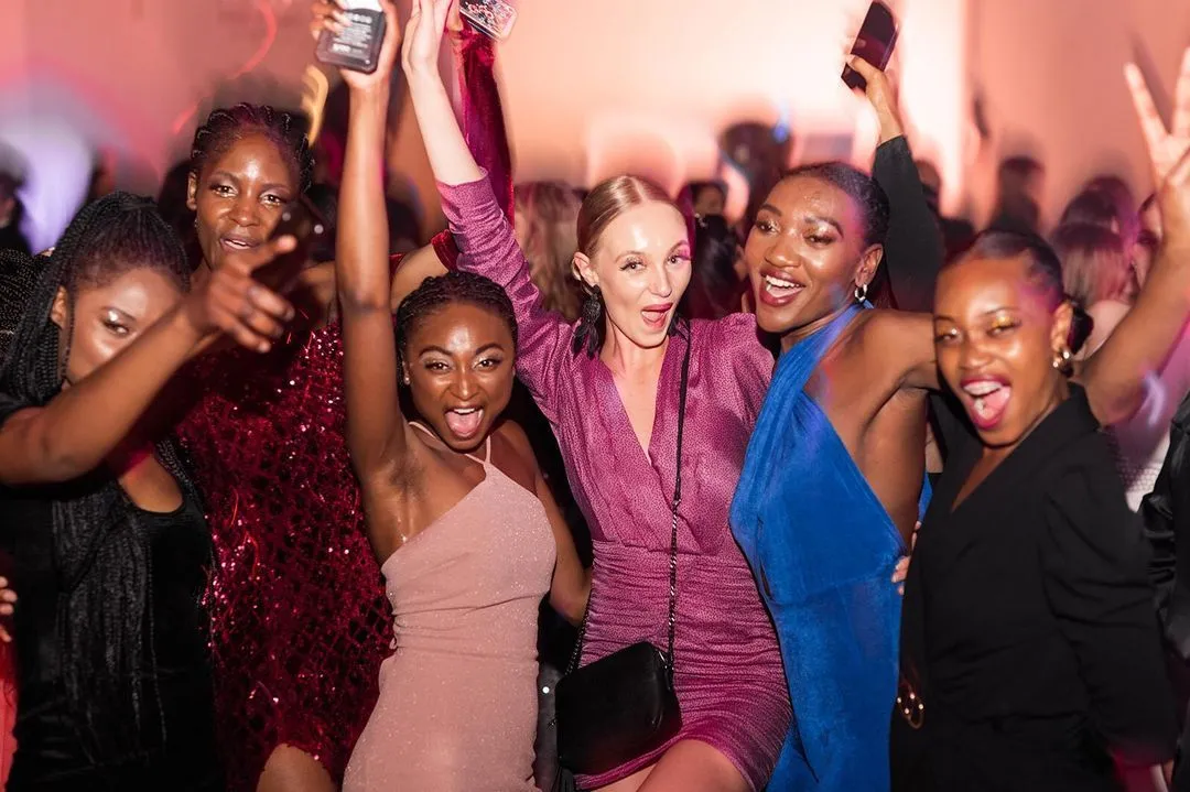Group of enthusiastic women enjoying a vibrant DJ event hosted by The DJ Company, dancing and capturing the moment on their phones