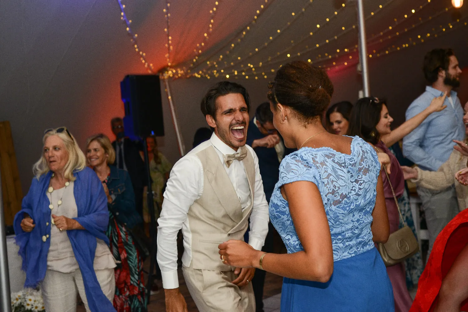 A groom singing along to his favourite some played by the DJ at his wedding up the west coast