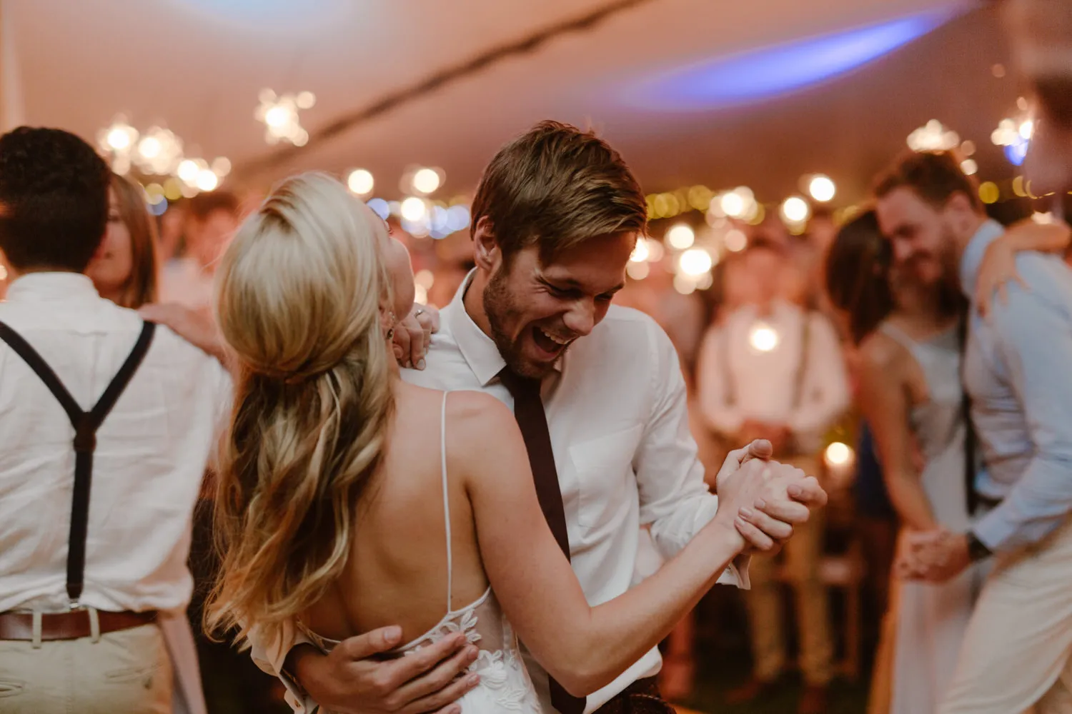 A couple smiling and having the time of their lives doing their first dance