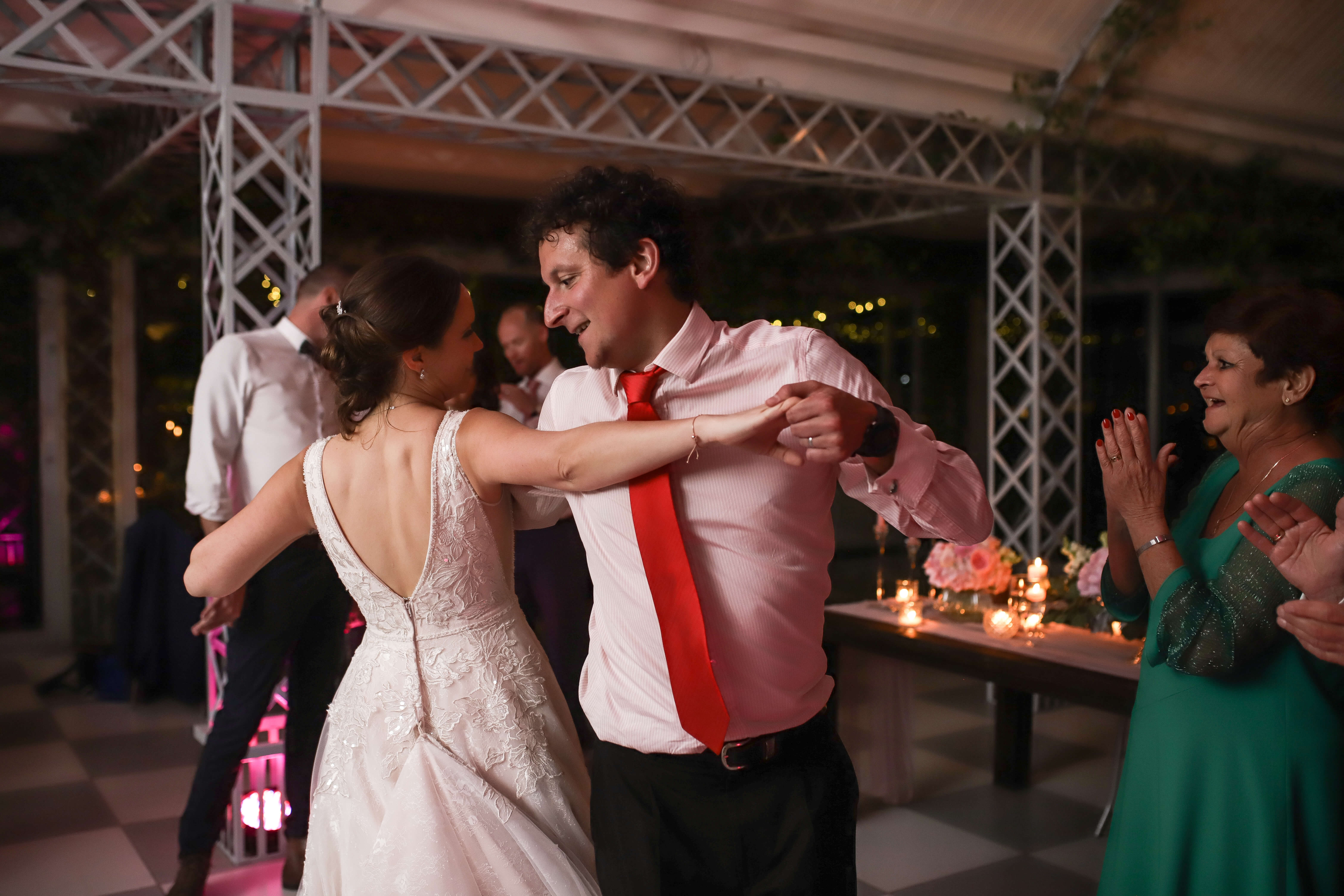 A bride and her friend dancing and swaying on her wedding night.