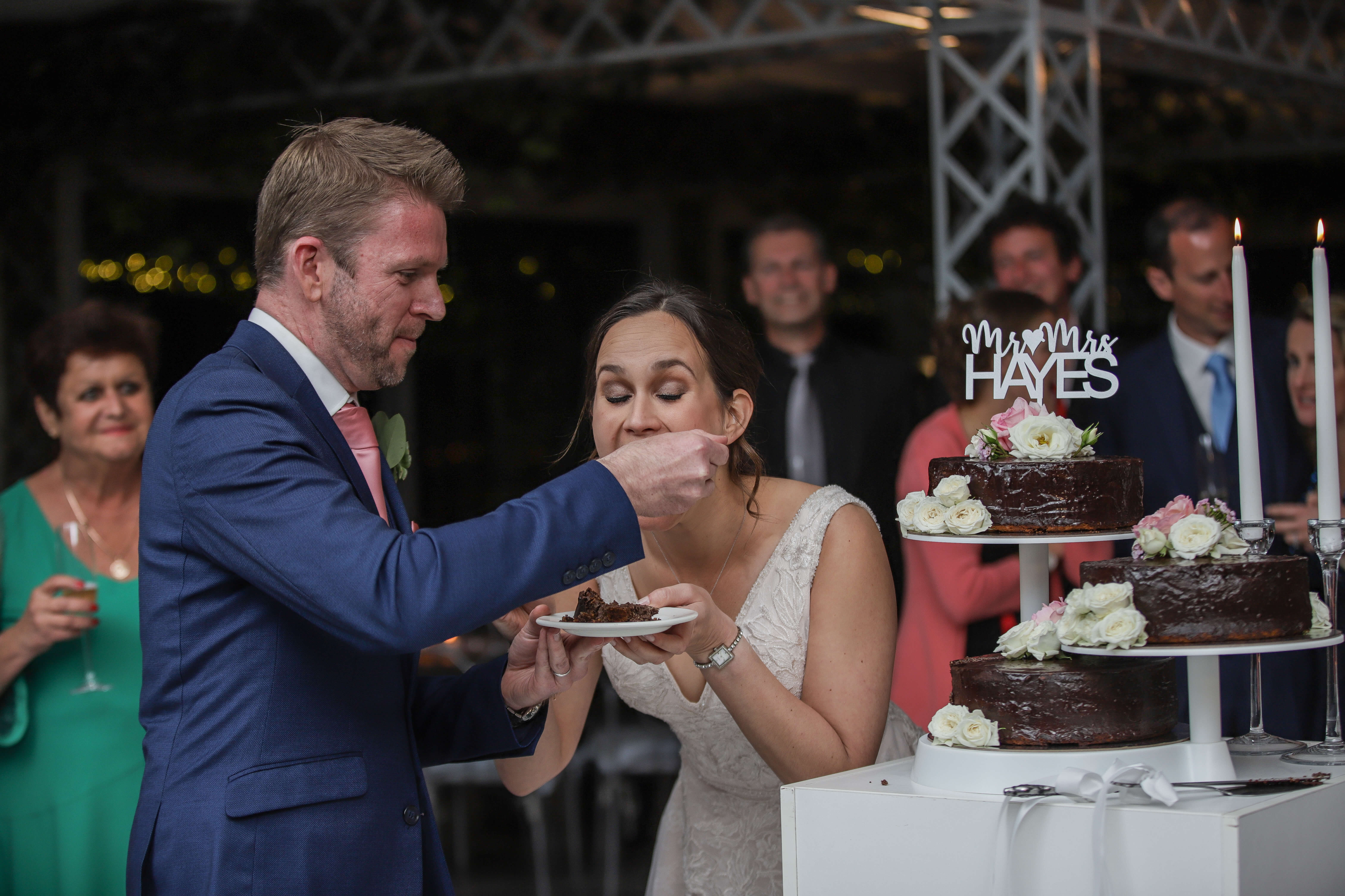 Bride and groom eating their wedding cake with a great song playing.