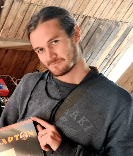 Adrian holding up a vinyl record