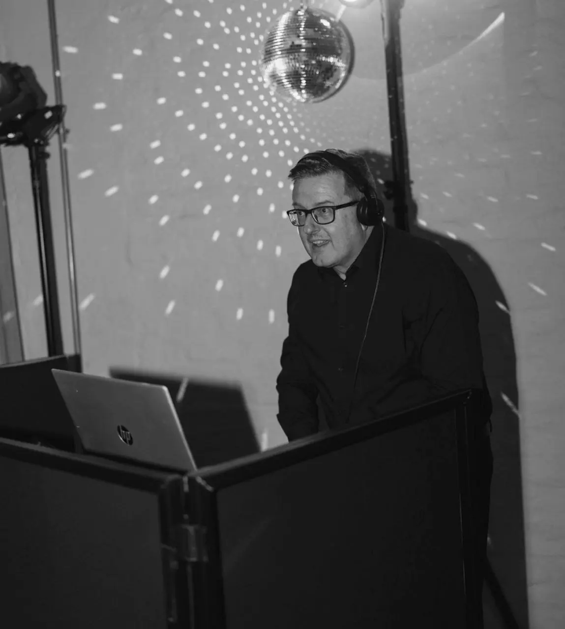 Greig at the decks under a mirror ball