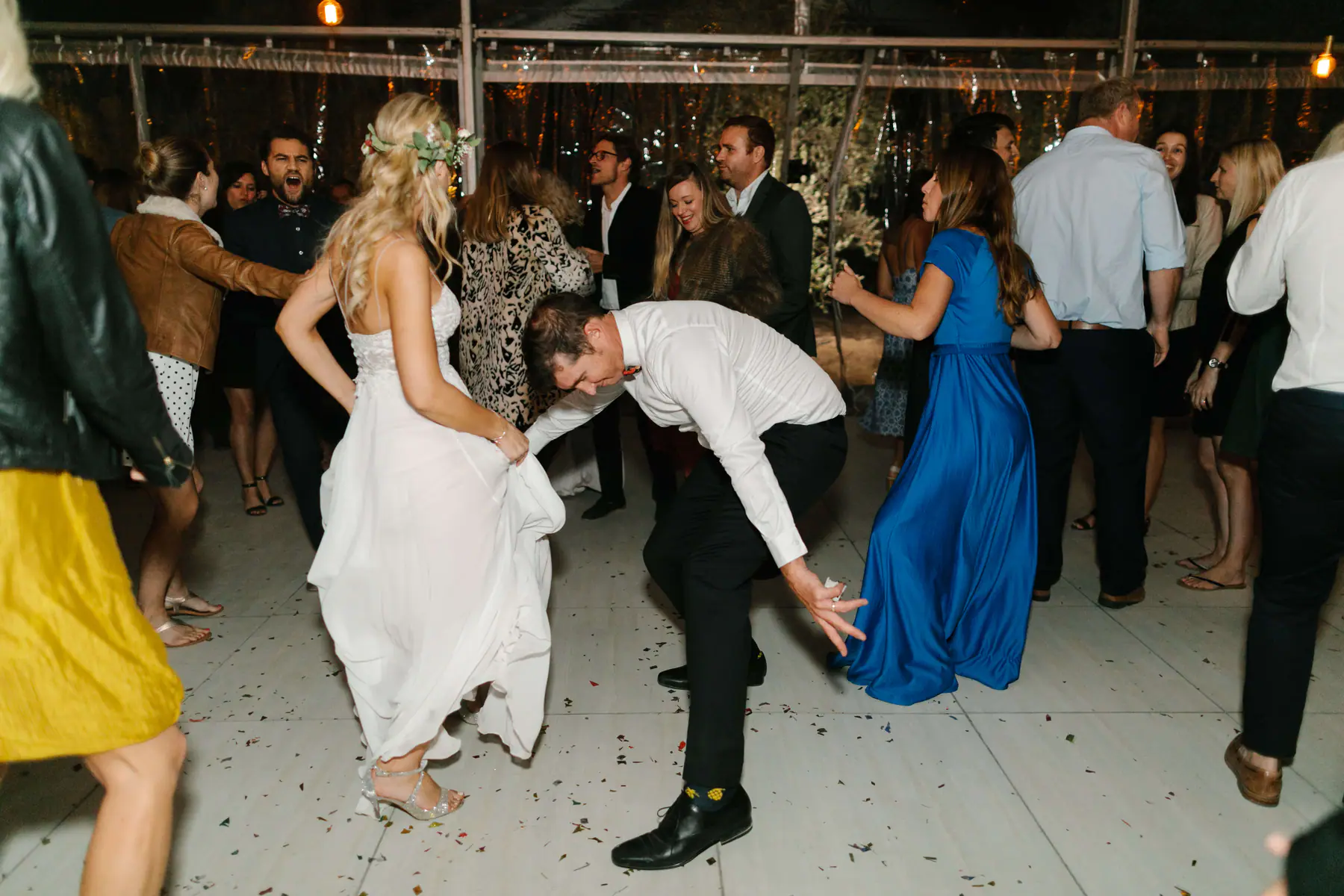 Mark bending low in a dance move as Louisa lifts her skirt on a confetti-strewn dance floor