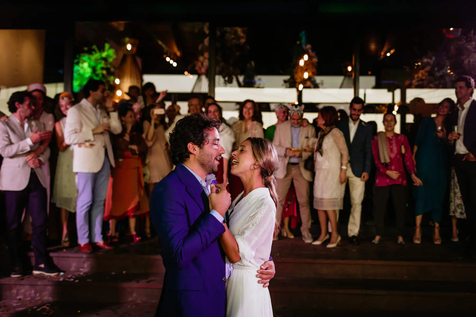 Barbara and Mario sing to each other during their first dance at Tokara as guests watch from the steps behind