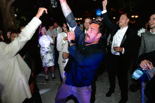 Guests dancing with their arms in the air at a wedding in Worcester