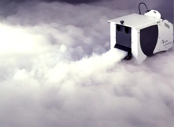 Low fog machine laying a thick white cloud of fog across the floor
