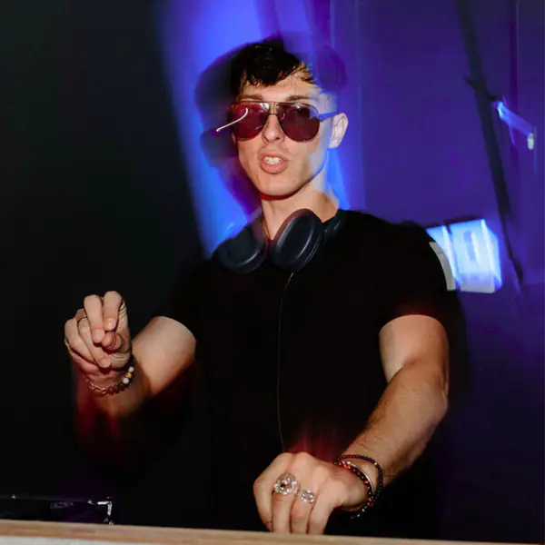 DJ in sunglasses and headphones mixing a set