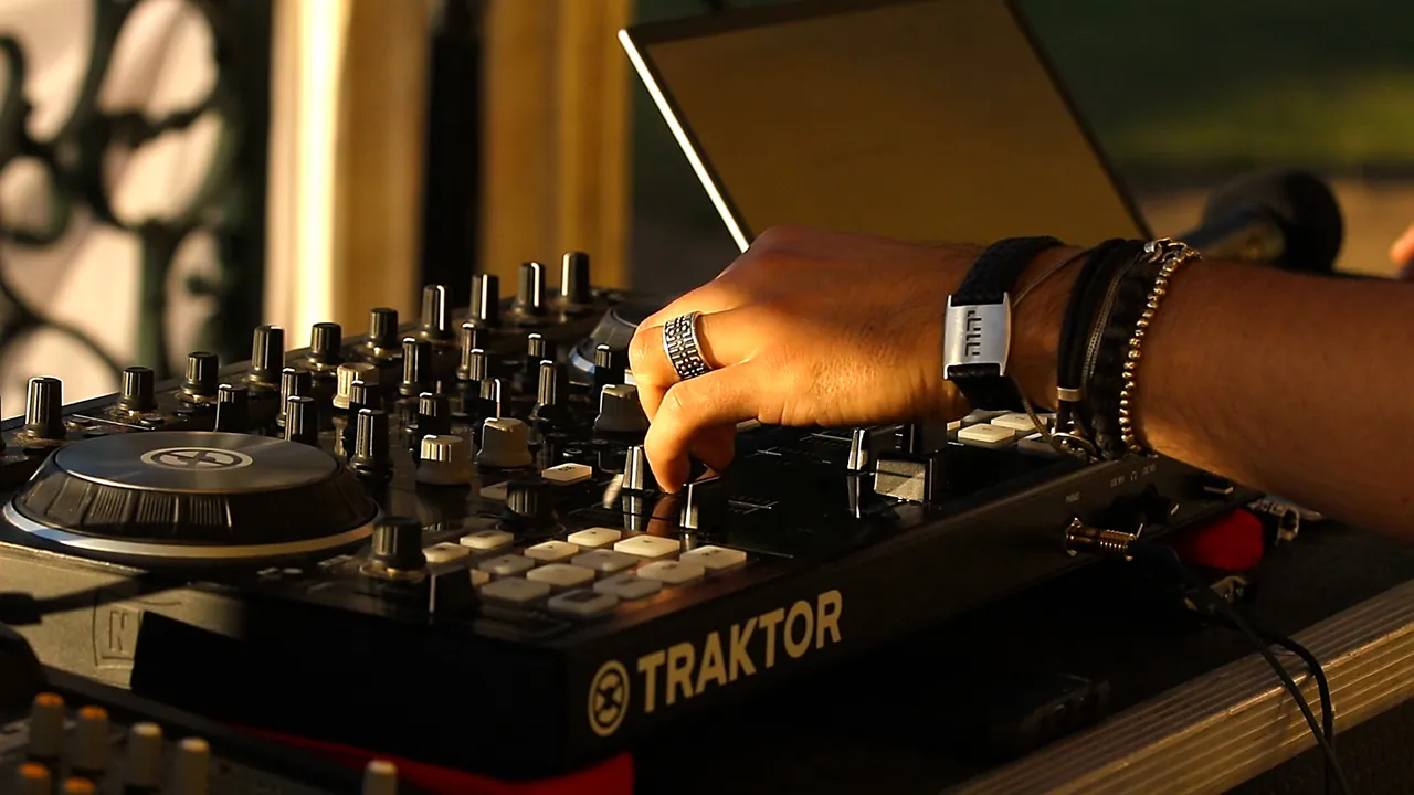 A hand on the DJ controller at the event